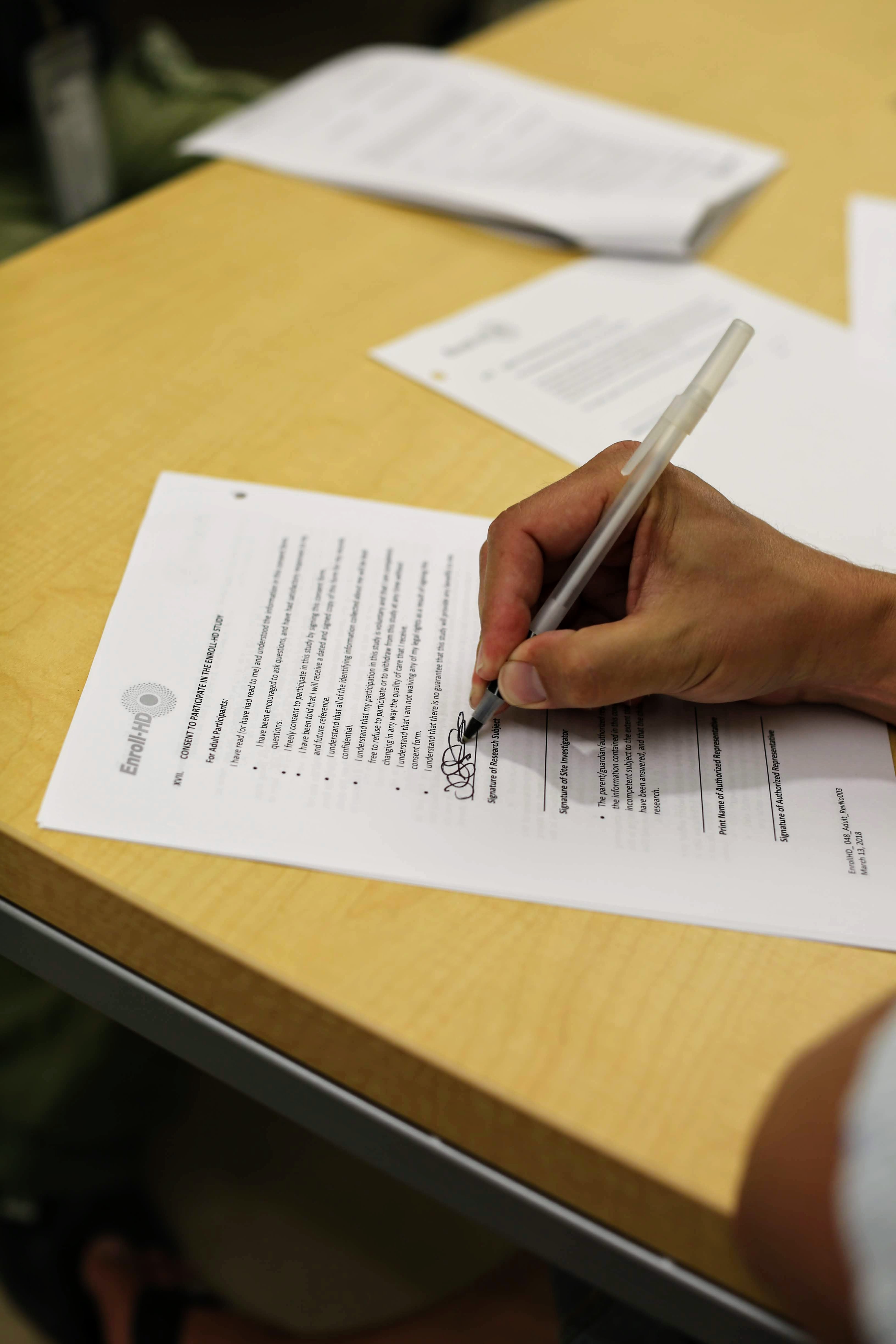 Jeff signs the ENROLL-HD consent form which is, believe it or not, totally understandable! And, yes, that's really my signature.
